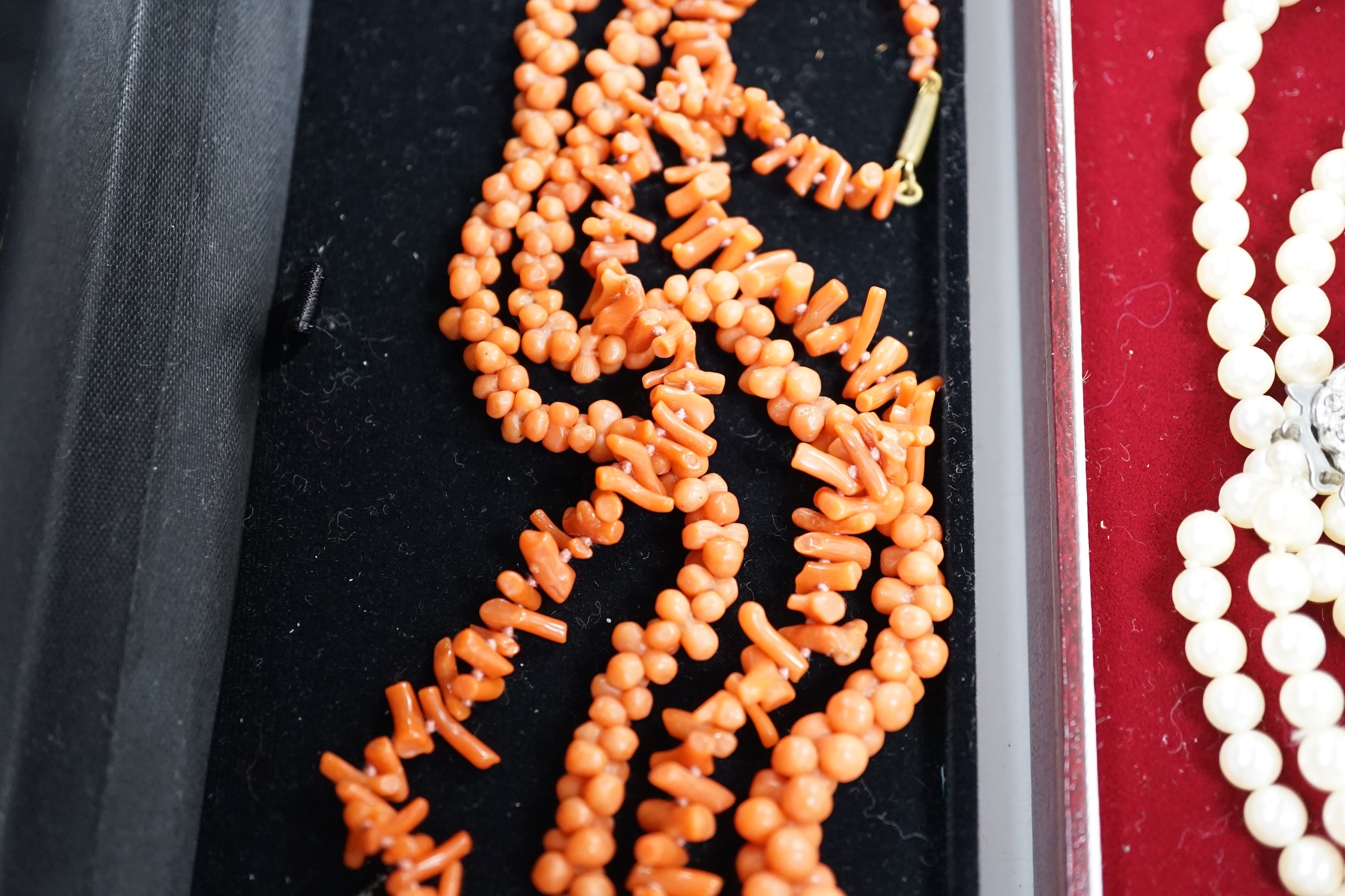 Two coral necklaces, one with beads the other branches, 33cm and a double strand cultured pearl necklace, with marcasite set clasp.